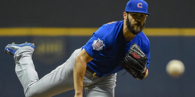 Oct 2, 2015; Milwaukee, WI, USA; Chicago Cubs pitcher Jake Arrieta (49) pitches in the first inning against the Milwaukee Brewers at Miller Park. Mandatory Credit: Benny Sieu-USA TODAY Sports