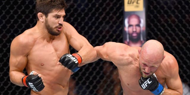 SASKATOON, SK - AUGUST 23: (L-R) Patrick Cote punches Josh Burkman of the United States in their welterweight bout during the UFC event at the SaskTel Centre on August 23, 2015 in Saskatoon, Saskatchewan, Canada. (Photo by Jeff Bottari/Zuffa LLC/Zuffa LLC via Getty Images)