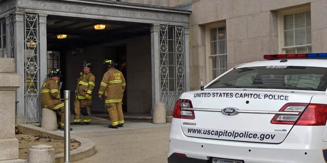 Jan. 15, 2016: Firefighters stand outside the Longworth House Office Building on Capitol Hill in Washington.