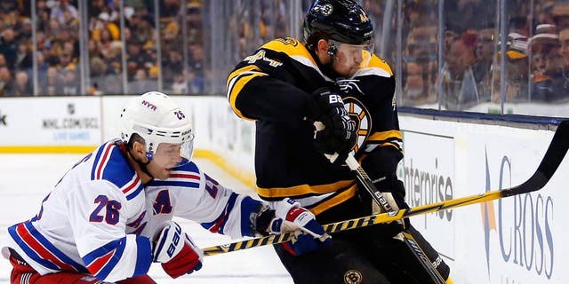 Jan 15, 2015; Boston, MA, USA; New York Rangers right wing Martin St. Louis (26) battles for the puck with Boston Bruins defenseman Dennis Seidenberg (44) during the second period at TD Garden. Mandatory Credit: Winslow Townson-USA TODAY Sports
