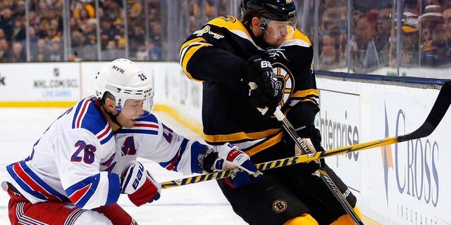 Jan 15, 2015; Boston, MA, USA; New York Rangers right wing Martin St. Louis (26) battles for the puck with Boston Bruins defenseman Dennis Seidenberg (44) during the second period at TD Garden. Mandatory Credit: Winslow Townson-USA TODAY Sports