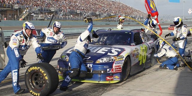 Jimmie Johnson makes a pit stop in the final laps as he won the 2010 NASCAR Sprint Cup Series championship at the Ford 400 race in Homestead, Florida November 21, 2010.