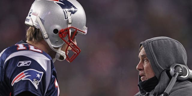 FOXBORO, MA - JANUARY 14: (L-R) Tom Brady #12 of the New England Patriots talks with head coach Bill Belichick on the sideline against the Denver Broncos during their AFC Divisional Playoff Game at Gillette Stadium on January 14, 2012 in Foxboro, Massachusetts. (Photo by Elsa/Getty Images)