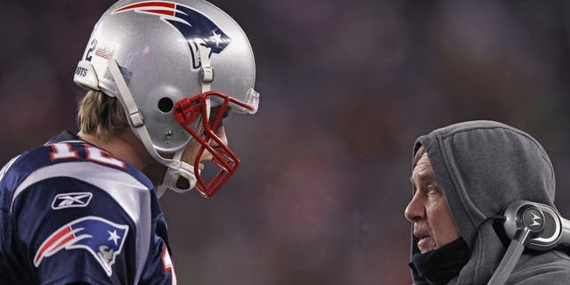FOXBORO, MA - JANUARY 14: (L-R) Tom Brady #12 of the New England Patriots talks with head coach Bill Belichick on the sideline against the Denver Broncos during their AFC Divisional Playoff Game at Gillette Stadium on January 14, 2012 in Foxboro, Massachusetts. (Photo by Elsa/Getty Images)