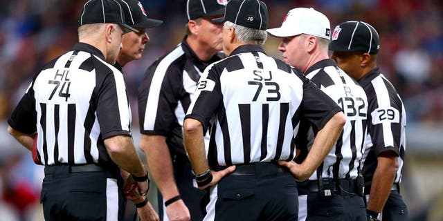 ST. LOUIS, MO - DECEMBER 22: Referee John Parry #132 holds a meeting with other officials during a game between the St. Louis Rams and the Tampa Bay Buccaneers at the Edward Jones Dome on December 22, 2013 in St. Louis, Missouri. The Rams beat the Buccaneers 23-13. (Photo by Dilip Vishwanat/Getty Images)
