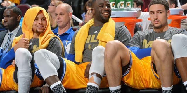 CLEVELAND, OH - JANUARY 18: Stephen Curry #30 of the Golden State Warriors smiles while resting on the bench along side Draymond Green #23 an Klay Thompson #11 against the Cleveland Cavaliers on January 18, 2016 at Quicken Loans Arena in Cleveland, Ohio. (Jesse D. Garrabrant/NBAE via Getty Images)