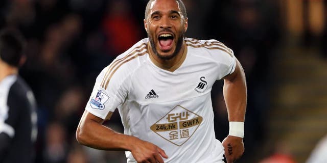 SWANSEA, WALES - JANUARY 18: Ashley Williams of Swansea City celebrates after scoring a goal to make it 1-0 during the Barclays Premier League match between Swansea City and Watford at the Liberty Stadium on January 18, 2016 in Swansea, Wales. (Photo by Matthew Ashton - AMA/Sports Photo Agency)