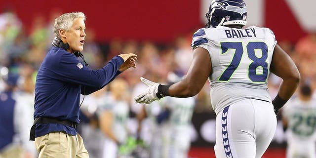 Oct 17, 2013; Phoenix, AZ, USA; Seattle Seahawks head coach Pete Carroll and offensive tackle Alvin Bailey against the Arizona Cardinals at University of Phoenix Stadium. Mandatory Credit: Mark J. Rebilas-USA TODAY Sports