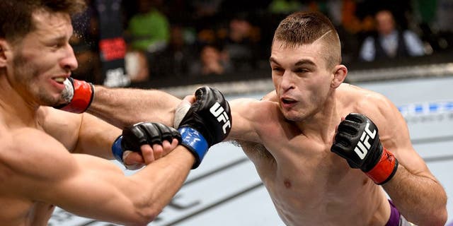 BOSTON, MA - JANUARY 18: (R-L) Johnny Case punches Frankie Perez in their lightweight fight during the UFC Fight Night event at the TD Garden on January 18, 2015 in Boston, Massachusetts. (Photo by Jeff Bottari/Zuffa LLC/Zuffa LLC via Getty Images)