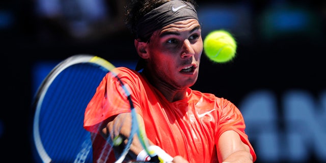 Jan. 20: Spain's Rafael Nadal makes a backhand return to Ryan Sweeting of the U.S. during their second round match at the Australian Open tennis championships in Melbourne, Australia.