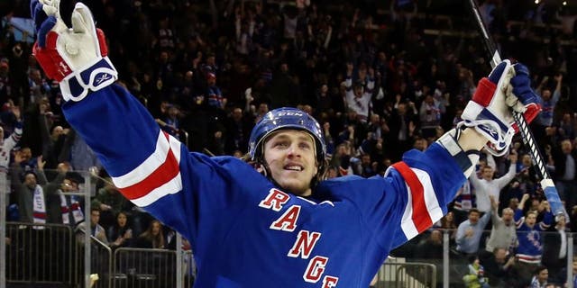 NEW YORK, NY - JANUARY 20: Carl Hagelin #62 of the New York Rangers celebrates his game winning goal against Craig Anderson #41 of the Ottawa Senators to defeat the Ottawa Senators in overtime in their game at Madison Square Garden on January 20, 2015 in New York City. (Photo by Bruce Bennett/Getty Images)