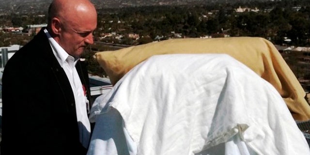 In this photo provided by the office of U.S. Rep Gabrielle Giffords, Giffords' husband, Mark Kelly, stands with his wife as she looks from her bed at the Santa Catalina Mountains while on an outdoor deck at University Medical Center in Tucson, Ariz., Thursday, Jan. 20, 2011. Giffords is scheduled to be flown to Houston on Friday to begin her rehabilitation. (AP Photo/Office of U.S. Rep. Gabrielle Giffords)