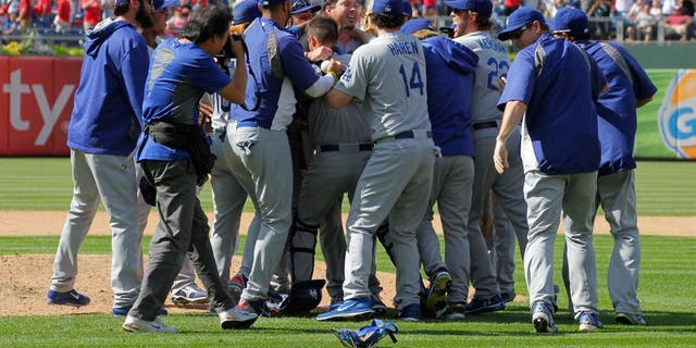 PHILADELPHIA - MAY 25: Starting pitcher Josh Beckett #61 of the Los Angeles Dodgers is swarmed by teammates after throwing a no hitter against the Philadelphia Phillies at Citizens Bank Park on May 25, 2014 in Philadelphia, Pennsylvania. The Dodgers won 6-0. (Photo by Hunter Martin/Getty Images)