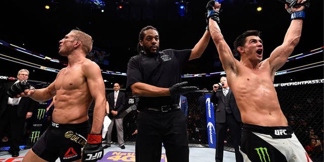 BOSTON, MA - JANUARY 17: Dominick Cruz (R) celebrates his split-decision victory over TJ Dillashaw (L) in their UFC bantamweight championship bout during the UFC Fight Night event inside TD Garden on January 17, 2016 in Boston, Massachusetts. (Photo by Jeff Bottari/Zuffa LLC/Zuffa LLC via Getty Images)