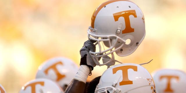 KNOXVILLE, TN - SEPTEMBER 7: A Tennessee Volunteer holds up his helmet in the team huddle before the NCAA football game against the Middle Tennessee State Blue Raiders at Neyland Stadium on September 7, 2002 in Knoxville, Tennessee. Tennessee won 26-3. (Photo by Elsa/Getty Images)