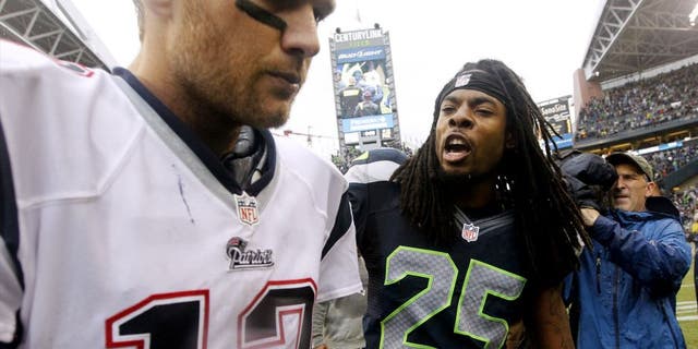 Seattle Seahawks' Richard Sherman (25) talks with New England Patriots quarterback Tom Brady after an NFL football game, Sunday, Oct. 14, 2012, in Seattle. The Seahawks won 24-23. (AP Photo/Elaine Thompson)