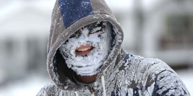 Michael Rainey got his face full of snow after tubing down the hill along Broad Street in Bristol, Tennessee.