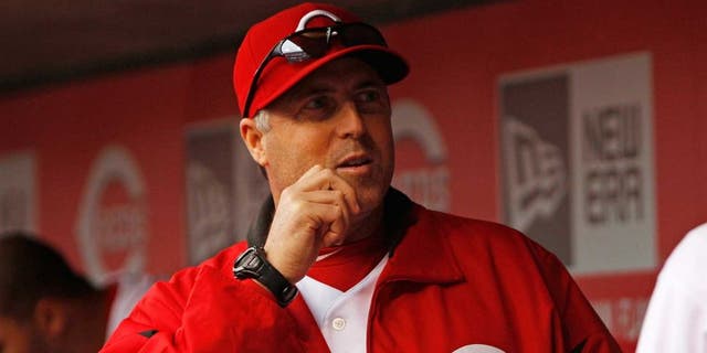 May 25, 2013; Cincinnati, OH, USA; Cincinnati Reds pitching coach Bryan Price (38) talks to starting pitcher Homer Bailey (34) during the seventh inning against the Chicago Cubs at Great American Ball Park. The Reds defeated the Cubs 5-2. Mandatory Credit: Frank Victores-USA TODAY Sports