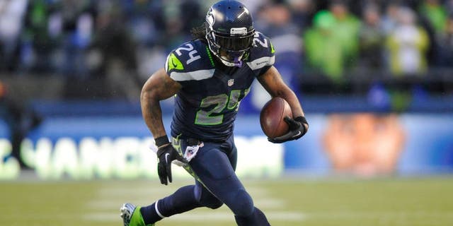 Jan 11, 2014; Seattle, WA, USA; Seattle Seahawks running back Marshawn Lynch (24) carries the ball against the New Orleans Saints during the second half of the 2013 NFC divisional playoff football game at CenturyLink Field. Seattle defeated New Orleans 23-15. Mandatory Credit: Steven Bisig-USA TODAY Sports