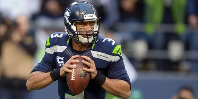 Jan 19, 2014; Seattle, WA, USA; Seattle Seahawks quarterback Russell Wilson (3) drops back to pass against the San Francisco 49ers during the first half of the 2013 NFC Championship football game at CenturyLink Field. Mandatory Credit: Kirby Lee-USA TODAY Sports