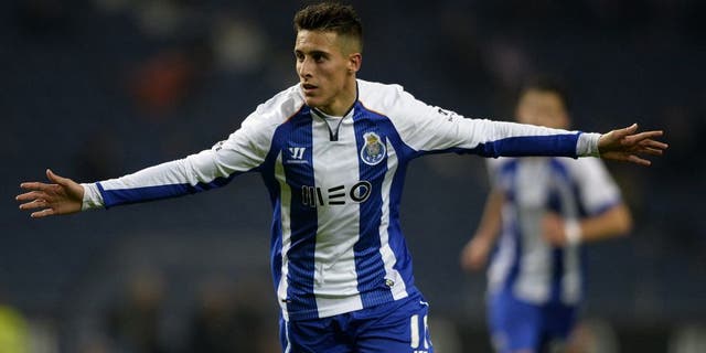 Porto's Spanish forward Cristian Tello celebrates with teammates after scoring a goal during the Portuguese league football match FC Porto v FC Pacos de Ferreira at the Dragao stadium in Porto on February 1, 2015. AFP PHOTO / MIGUEL RIOPA (Photo credit should read MIGUEL RIOPA/AFP/Getty Images)