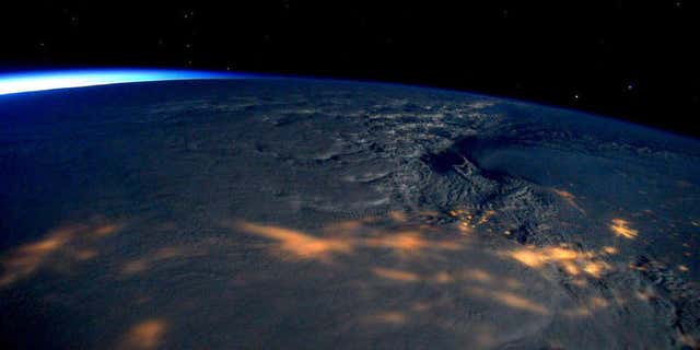 This image made available by NASA via Twitter posted on Saturday, Jan. 23, 2016, by space station commander Scott Kelly, shows a view from the International Space Station of a storm passing over the United States.