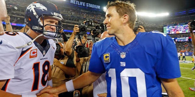 EAST RUTHERFORD, NJ - SEPTEMBER 15: (NEW YORK DAILIES OUT) Quarterbacks Peyton Manning #18 of the Denver Broncos and Eli Manning #10 of the New York Giants meet after their game on September 15, 2013 at MetLife Stadium in East Rutherford, New Jersey. The Broncos defeated the Giants 41-23. (Photo by Jim McIsaac/Getty Images)