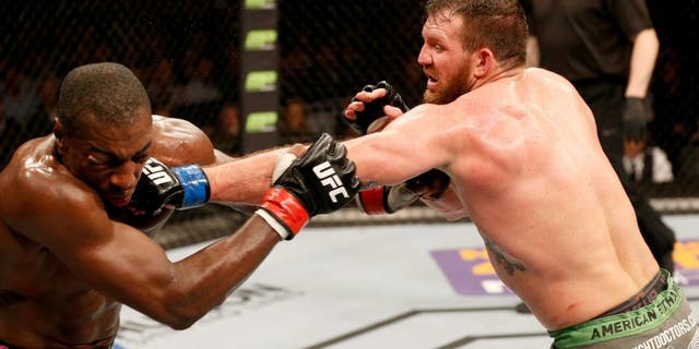 STOCKHOLM, SWEDEN - JANUARY 24: (R-L) Ryan Bader of the United States punches Phil Davis of the United States in their light heavyweight bout during the UFC Fight Night event at the Tele2 Arena on January 24, 2015 in Stockholm, Sweden. (Photo by Josh Hedges/Zuffa LLC/Zuffa LLC via Getty Images)