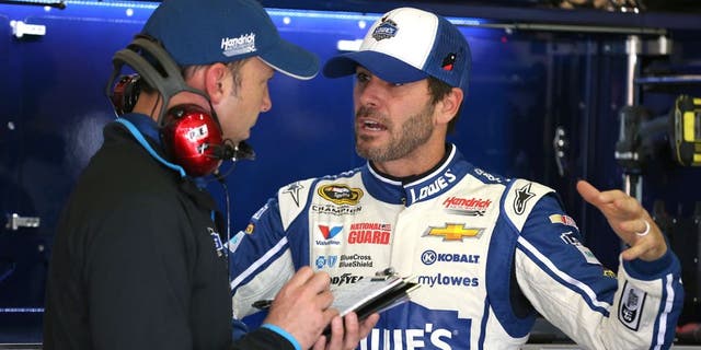 FONTANA, CA - MARCH 21: Jimmie Johnson (right), driver of the #48 Lowe's Chevrolet, speaks with crew chief Chad Knaus during practice for the NASCAR Sprint Cup Series Auto Club 400 at Auto Club Speedway on March 21, 2014 in Fontana, California. (Photo by Robert Laberge/Getty Images)