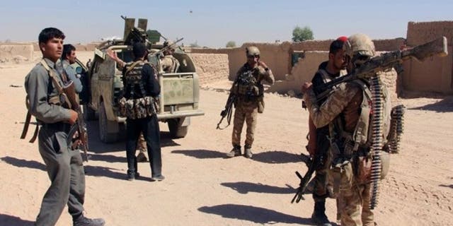 Afghan Special Forces and policemen prepare themselves for battle with the Taliban on the outskirts of Lashkar Gah capital of Helmand, Afghanistan October 10, 2016.