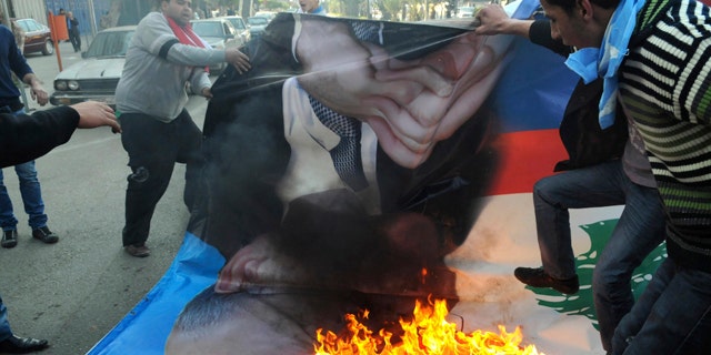 Jan. 25: Angry Sunni protesters burn a poster of former premier Najib Mikati in the northern port city of Tripoli, Lebanon.