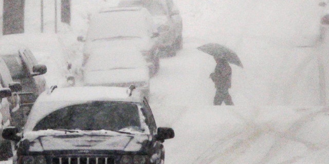 Jan. 26: A person with an umbrella crosses the street as snow falls in Belleville, N.J.