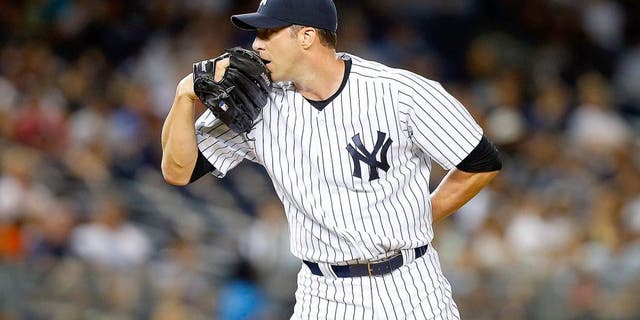 NEW YORK, NY - AUGUST 20: Chris Capuano #26 of the New York Yankees in action against the Cleveland Indians at Yankee Stadium on August 20, 2015 in the Bronx borough of New York City. The Indians defeated the Yankees 3-2. (Photo by Jim McIsaac/Getty Images)