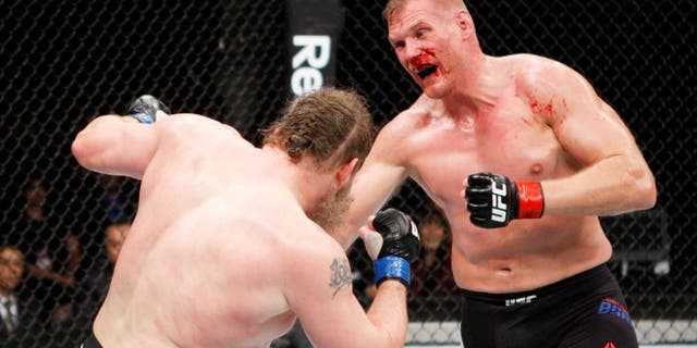 SAITAMA, JAPAN - SEPTEMBER 27: (From L to R) Roy Nelson of the United States of America and Josh Barnett of the United States of America exchange punches in their heavyweight bout during the UFC event at the Saitama Super Arena on September 27, 2015 in Saitama, Japan. (Photo by Mitch Viquez/Zuffa LLC/Zuffa LLC via Getty Images)