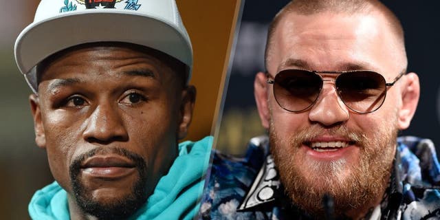 Floyd Mayweather Jr. attends a post-fight news conference at MGM Grand Hotel & Casino after he retained his WBC/WBA welterweight titles in a unanimous-decision victory over Andre Berto on September 12, 2015 in Las Vegas, Nevada. (Photo by Ethan Miller/Getty Images) UFC featherweight champion and lightweight challenger Conor McGregor of Ireland interacts with the media during the UFC 197 on-sale press conference event inside MGM Grand Hotel & Casino on January 20, 2016 in Las Vegas, Nevada. (Photo by Jeff Bottari/Zuffa LLC/Zuffa LLC via Getty Images)