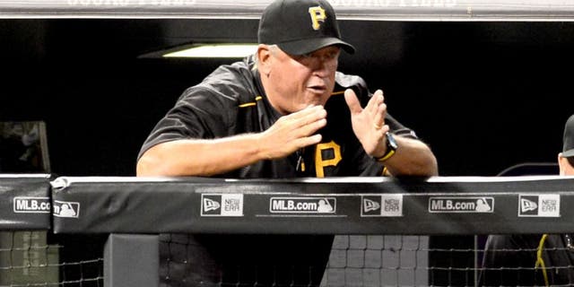 Sep 21, 2015; Denver, CO, USA; Pittsburgh Pirates manager Clint Hurdle (13) calls out from the dugout in the fifth inning against the Colorado Rockies at Coors Field. Mandatory Credit: Ron Chenoy-USA TODAY Sports