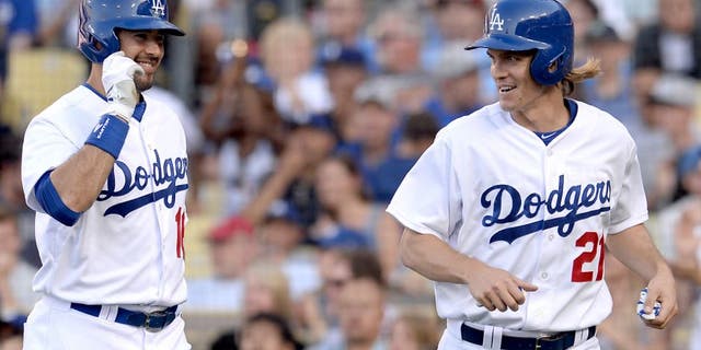 Jun 7, 2015; Los Angeles, CA, USA; Los Angeles Dodgers starting pitcher Zack Greinke (21) is met by right fielder Andre Ethier (16) after he crossed the plate for a run off a single by third baseman Justin Turner (10) in the third inning of the game against the St. Louis Cardinals at Dodger Stadium. Mandatory Credit: Jayne Kamin-Oncea-USA TODAY Sports
