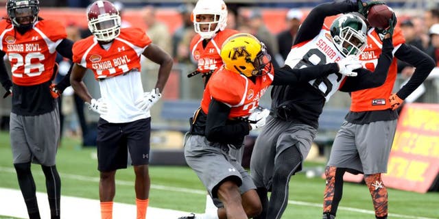 Jan 26, 2016; Mobile, AL, USA; North squad wide receiver Aaron Burbridge of Michigan State (86) makes a catch near the sideline as defensive back Eric Murray of Minnesota (31) defends during Senior Bowl practice at Ladd-Peebles Stadium. Mandatory Credit: Glenn Andrews-USA TODAY Sports