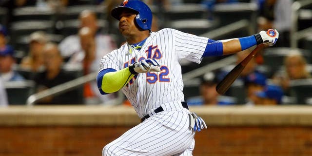 NEW YORK, NY - SEPTEMBER 14: Yoenis Cespedes #52 of the New York Mets hits a third-inning home run against the Miami Marlins at Citi Field on September 14, 2015 in the Flushing neighborhood of the Queens borough of New York City. (Photo by Jim McIsaac/Getty Images)