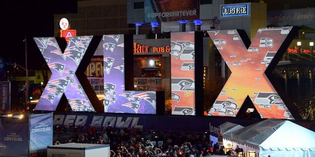 Jan 28, 2015; Phoenix, AZ, USA; General view of the Super Bowl XLIX roman numerals with the logos of the Seattle Seahawks and the New England Patriots at Super Bowl Central. Mandatory Credit: Kirby Lee-USA TODAY Sports