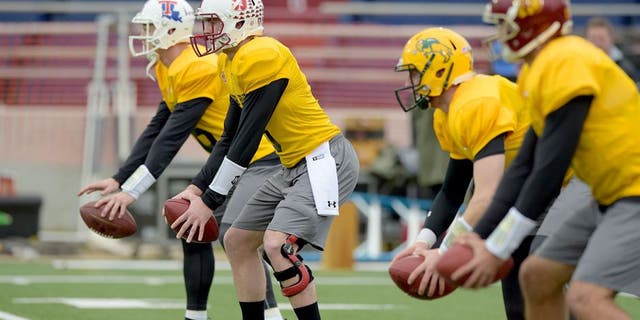 Jan 26, 2016; Mobile, AL, USA; North squad quarterback Jeff Driskel of Louisiana Tech (far left) and quarterback Kevin Hogan of Stanford (left) and quarterback Carson Wentz of North Dakota State (right) and quarterback Cody Kessler of USC (far right) take snaps during Senior Bowl practice at Ladd-Peebles Stadium. Mandatory Credit: Glenn Andrews-USA TODAY Sports