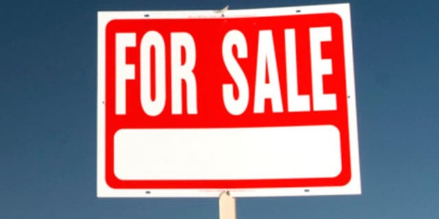 For sale sign in barren landscape.