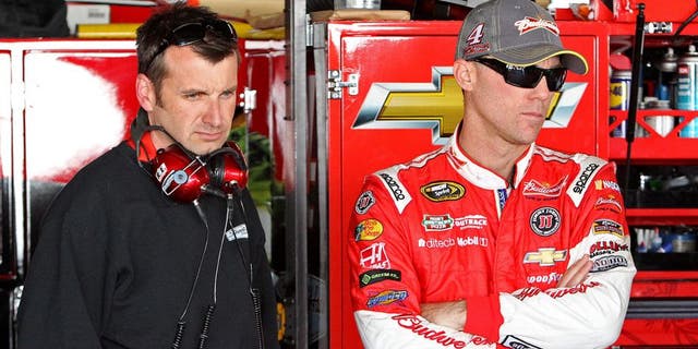 Sep 26, 2014; Dover, DE, USA; NASCAR Sprint Cup driver Kevin Harvick and NASCAR Sprint Cup Series crew chief Rodney Childers stand in the garage during practice for the AAA 400 at Dover International Speedway. Mandatory Credit: Matthew O'Haren-USA TODAY Sports
