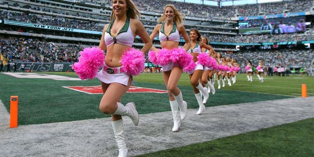 Oct 18, 2015; East Rutherford, NJ, USA; The New York Jets cheerleaders run on the field prior to the game against the Washington Redskins at MetLife Stadium. Mandatory Credit: Brad Penner-USA TODAY Sports