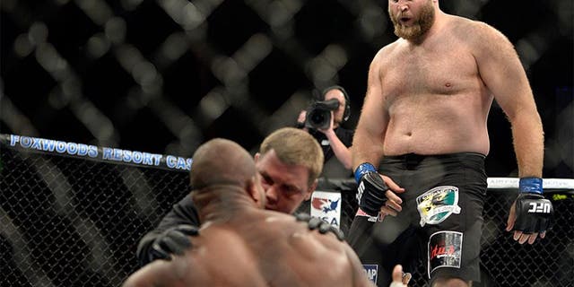 MASHANTUCKET, CT - SEPTEMBER 5: (R-L) Ben Rothwell dances over Alistair Overeem after defeating Overeem in their heavyweight weight fight during the UFC Fight Night event inside the Grand Theatre at Foxwoods Resort Casino on September 5, 2014 in Mashantucket, Connecticut. (Photo by Jeff Bottari/Zuffa LLC/Zuffa LLC via Getty Images) *** Local Caption ***Alistair Overeem;Ben Rothwell