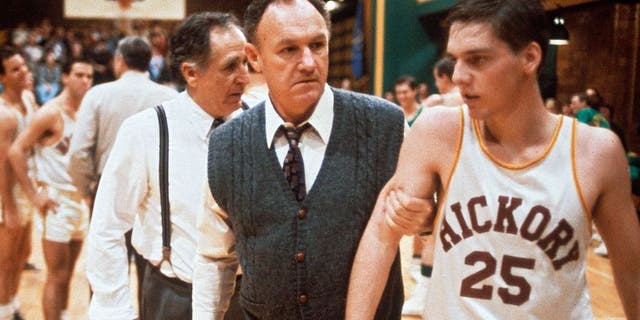 "The coach Norman Dale, played by the American actor Gene Hackman, grasps to the arm of a basketball player before a match and rebukes him, in a scene from the engaging dramatic movie Hoosiers. USA, 1986. (Photo by Mondadori Portfolio via Getty Images)"