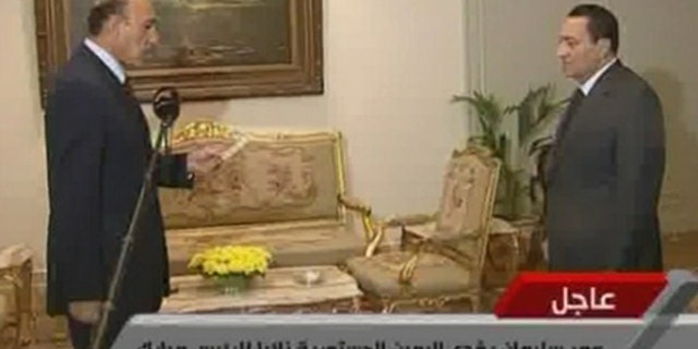 Jan. 29: In this image taken from TV, Egyptian President Hosni Mubarak, right, listens as Omar Suleiman swears the oath as Vice President of Egypt.