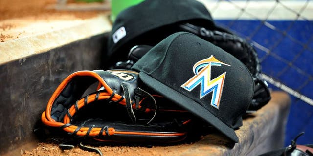March 6, 2012; Miami, FL, USA; Miami Marlins baseball glove and hat are seen in the dugout during a spring training game against the Miami Hurricanes at Marlins Park. Mandatory Credit: Steve Mitchell-USA TODAY Sports