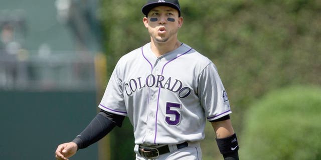 May 30, 2015; Philadelphia, PA, USA; Colorado Rockies right fielder Carlos Gonzalez (5) warms up before the first inning against the Philadelphia Phillies at Citizens Bank Park. Mandatory Credit: Bill Streicher-USA TODAY Sports