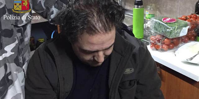 In this photo released by the Italian Police Friday, Jan. 29, 2016, Giuseppe Crea, sits in the hidden bunker where he was arrested.